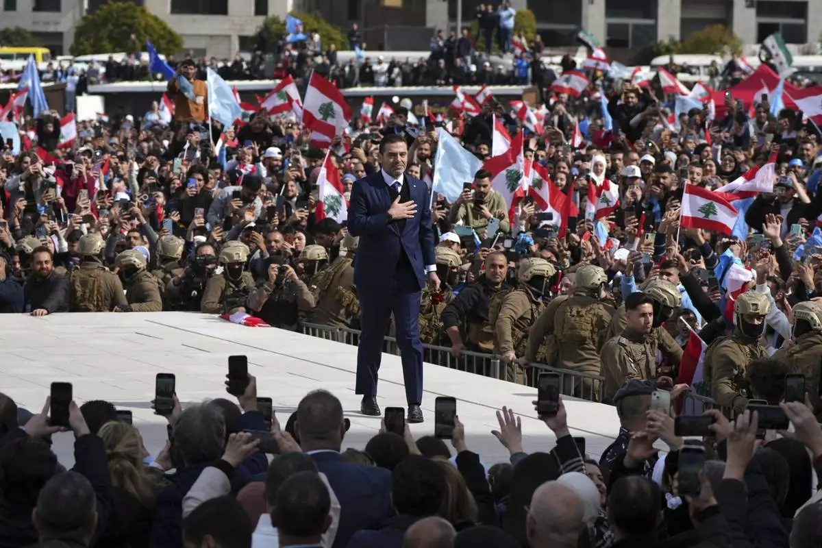 Former Lebanese Prime Minister Saad Hariri greets his supporters after he paid his respects at the grave of his father, former Prime Minister Rafik Hariri, on the 20th anniversary of his assassination in Beirut, Lebanon, Friday, Feb. 14, 2025. (AP Photo/Hassan Ammar)