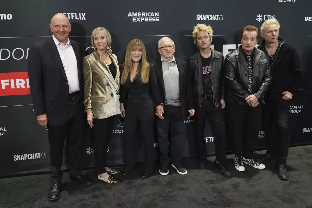 Steve Ballmer, from left, Connie Snyder, Shelli Azoff, and Irving Azoff, pose with Billie Joe Armstrong, Tre Cool, and Mike Dirnt of Green Day upon arrival at the FireAid benefit concert on Thursday, Jan. 30, 2025, at Intuit Dome in Inglewood, Calif. (Photo by Jordan Strauss/Invision/AP)