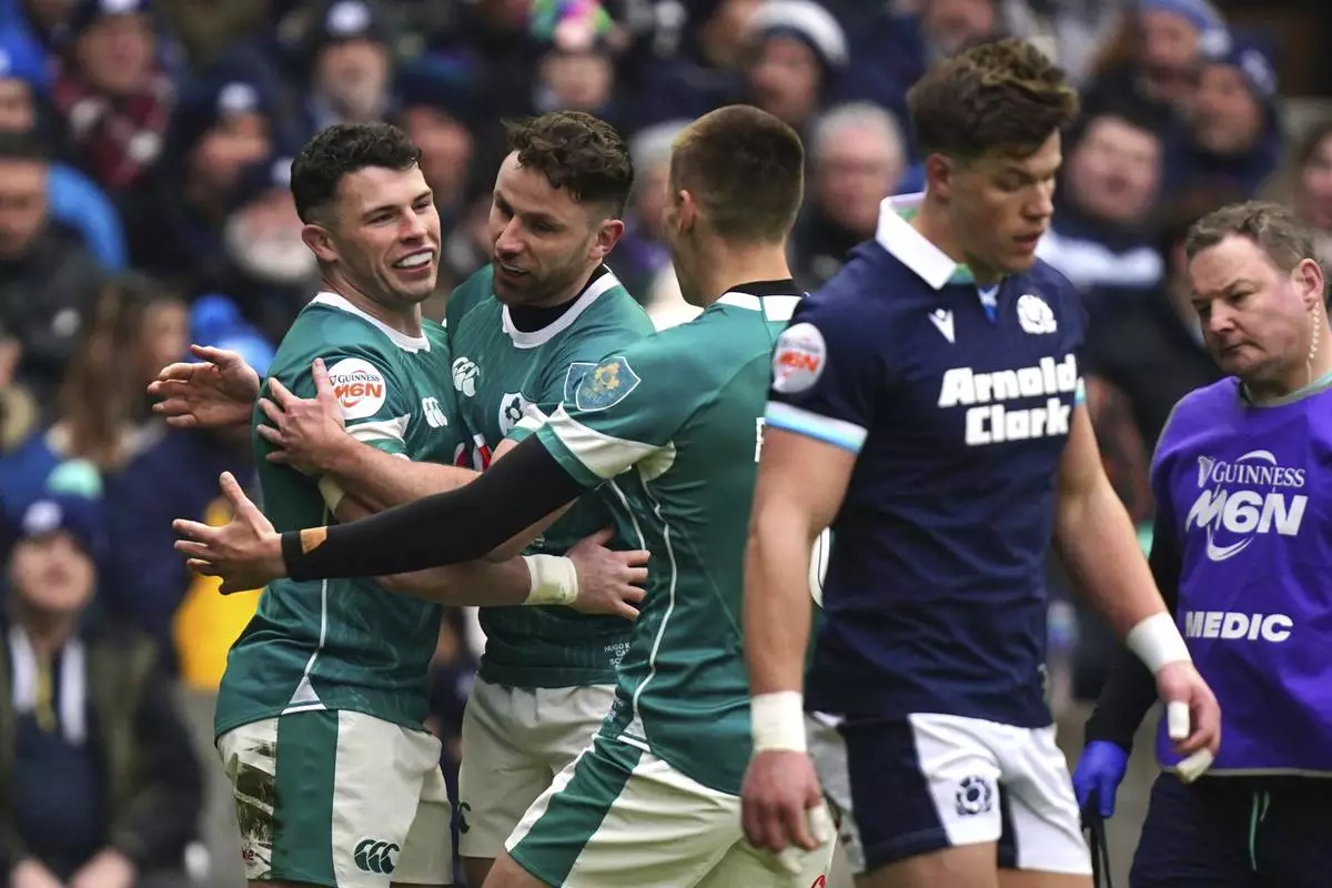 CORRECTS ID Ireland's Calvin Nash left, celebrates after scoring a try during the Six Nations match between Scotland and Ireland at Murrayfield Stadium, Edinburgh, Sunday Feb. 9, 2025. (Jane Barlow/PA via AP)
