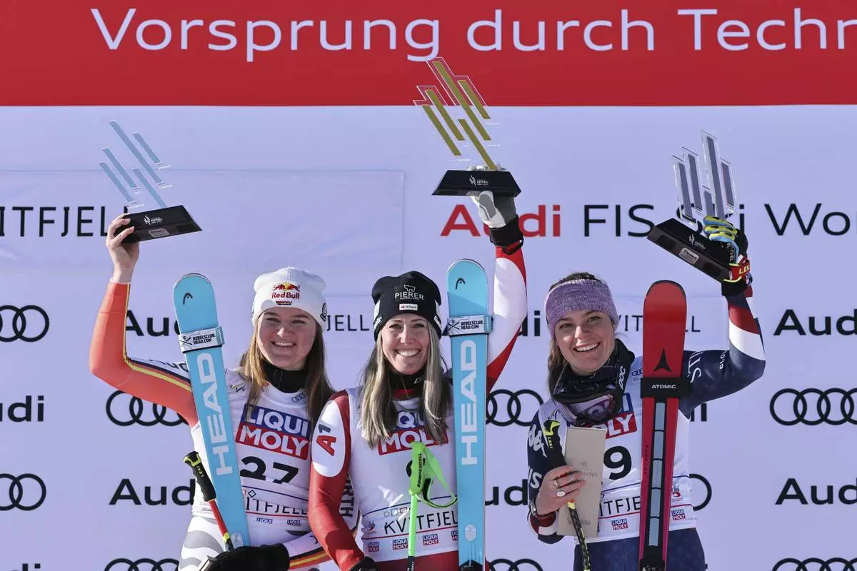 From left, second placed Germany's Emma Aicher, the winner Austria's Cornelia Huetter and third placed United States' Breezy Johnson celebrate after completing an alpine ski, women's World Cup downhill, in Kvitfjell, Norway, Friday, Feb. 28, 2025. (AP Photo/Marco Trovati)