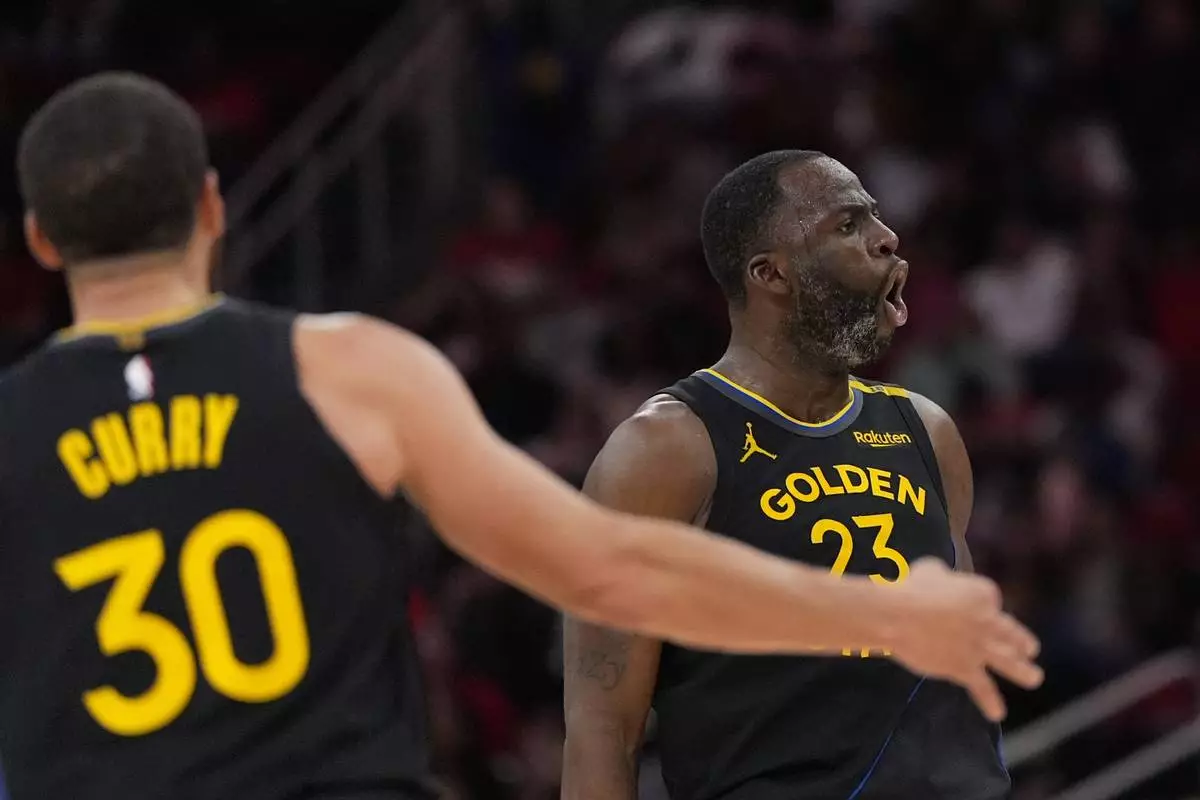 Golden State Warriors' Draymond Green (23) celebrates after making a 3-pointer against the Houston Rockets during the second half of an NBA basketball game Thursday, Feb. 13, 2025, in Houston. (AP Photo/David J. Phillip)