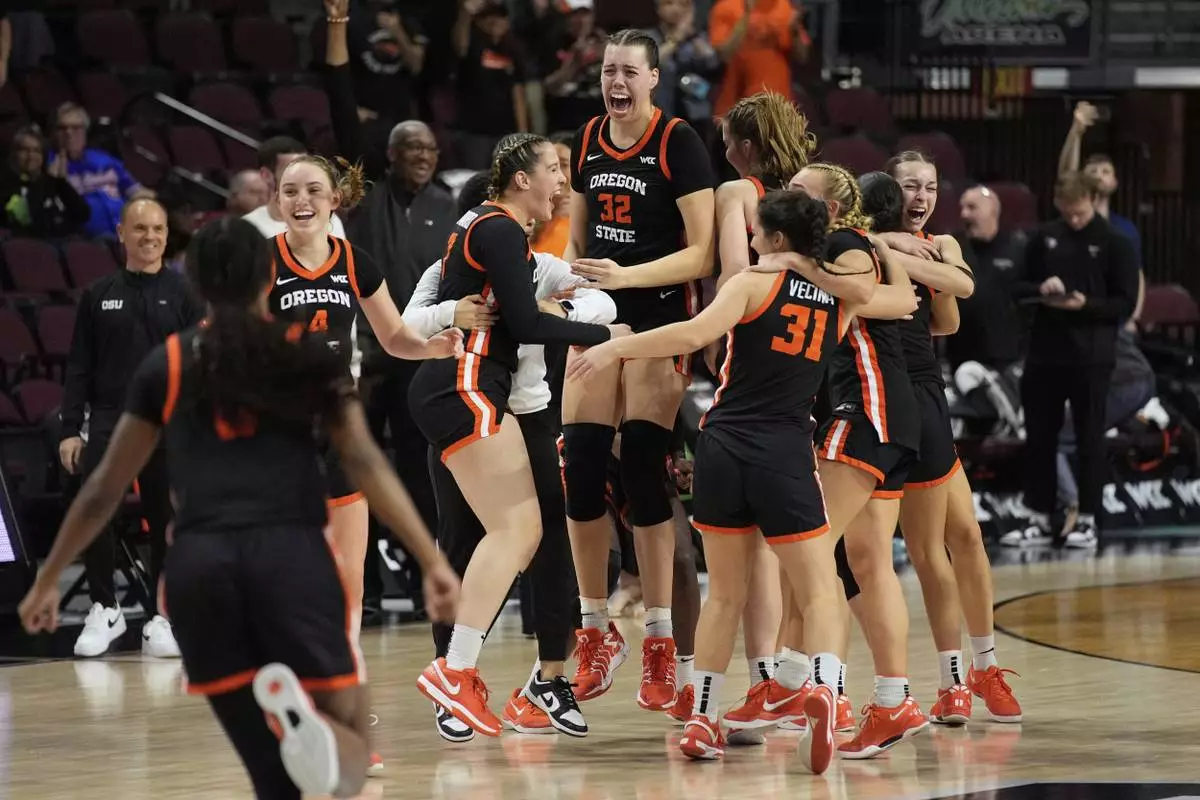 Oregon State players celebrates after defeating Portland in an NCAA college basketball game in the final of the West Coast Conference women's tournament Tuesday, March 11, 2025, in Las Vegas. (AP Photo/John Locher)