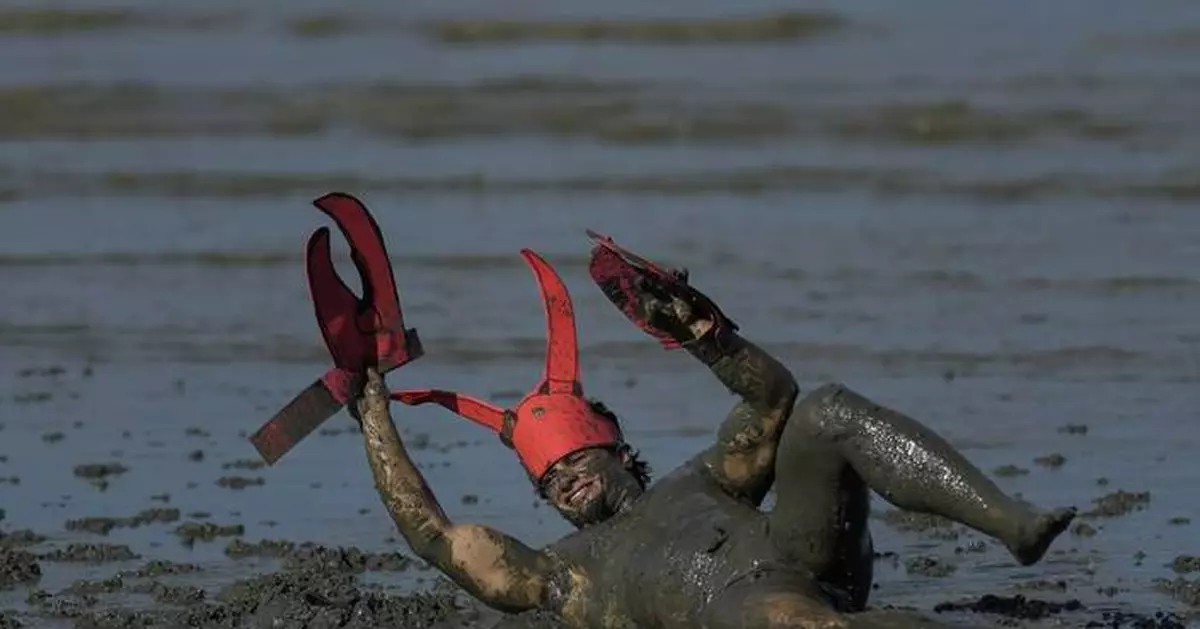 Mud-covered Carnival revelers are a strange sight in sleepy Brazilian town