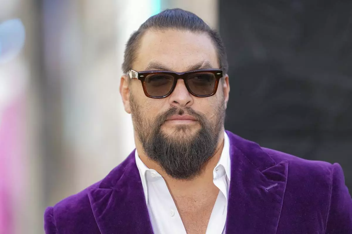 Jason Momoa pose for photographers upon arrival at the World premiere of A Minecraft Movie on Sunday, March 30, 2025, in London. (Photo by Scott A Garfitt/Invision/AP)