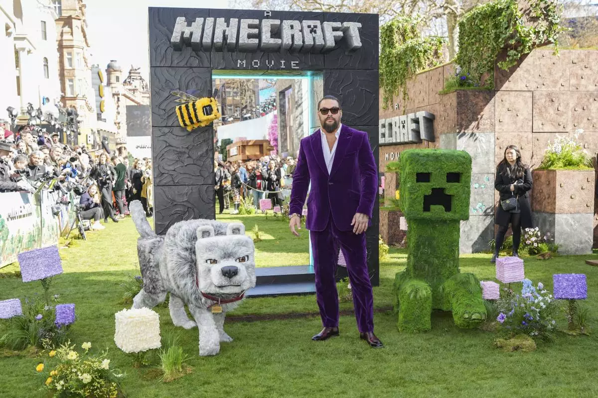 Jason Momoa pose for photographers upon arrival at the World premiere of A Minecraft Movie on Sunday, March 30, 2025, in London. (Photo by Scott A Garfitt/Invision/AP)