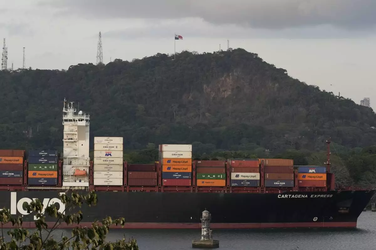 A cargo ship sails past the Panama Canal's Port of Balboa in Panama City, Thursday, March 13, 2025. (AP Photo/Matias Delacroix)