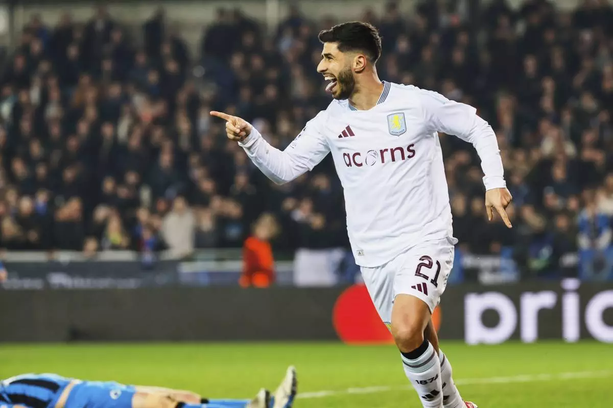 Aston Villa's Marco Asensio celebrates after an own goal by Brugge's Brandon Mechele made it past Brugge's goalkeeper Simon Mignolet during the Champions League round of 16 first leg soccer match between Club Brugge and Aston Villa at the Jan Breydel Stadium in Bruges, Belgium, Tuesday, March 4, 2025. (AP Photo/Geert Vanden Wijngaert)