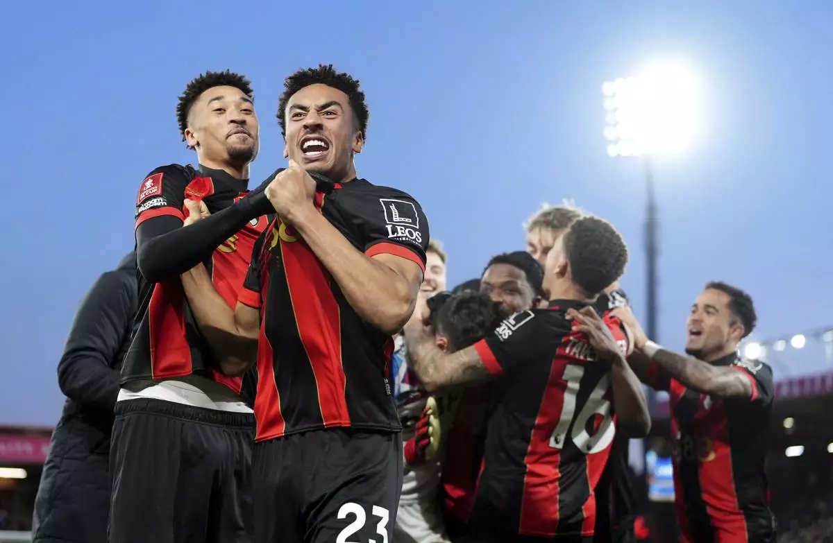 Bournemouth's James Hill, front, and his teammates celebrate winning on penalties during the FA Cup fifth round match between Wolverhampton and Bournemouth, Saturday, March 1, 2025, at the Vitality Stadium in Bournemouth, England. (Adam Davy/PA via AP)