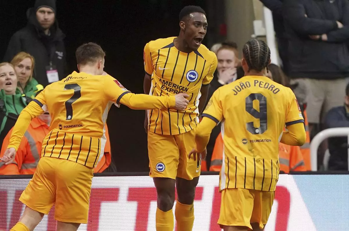 Brighton and Hove Albion's Danny Welbeck, centre, celebrates with teammates after scoring their side's second goal during the FA Cup fifth round match between Newcastle United and Brighton and Hove Albion at St James' Park, Newcastle, England, Sunday, March 2, 2025. (Owen Humphreys/PA via AP)