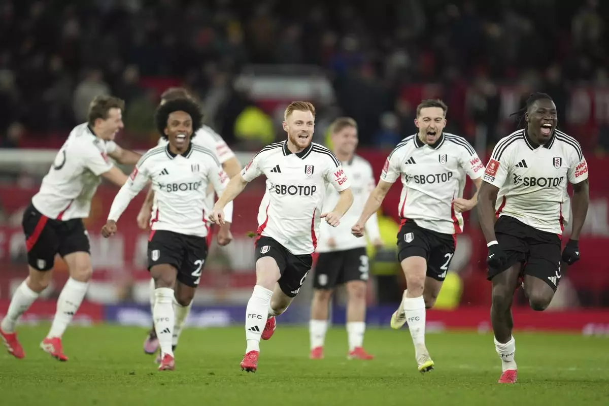 Fulham players celebrate after defeating Manchester United in a penalty shootout during the English FA Cup soccer match at the Old Trafford stadium in Manchester, England, Sunday, March 2, 2025. (AP Photo/Jon Super)