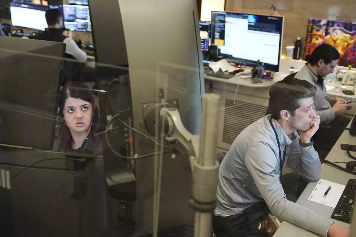 People work on the options floor at the New York Stock Exchange in New York, Monday, March 24, 2025. (AP Photo/Seth Wenig)
