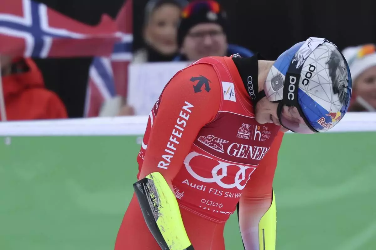Switzerland's Marco Odermatt reacts after completing an alpine ski, men's World Cup downhill, in Kvitfjell, Norway, Saturday, March 8, 2025. (AP Photo/Marco Trovati)
