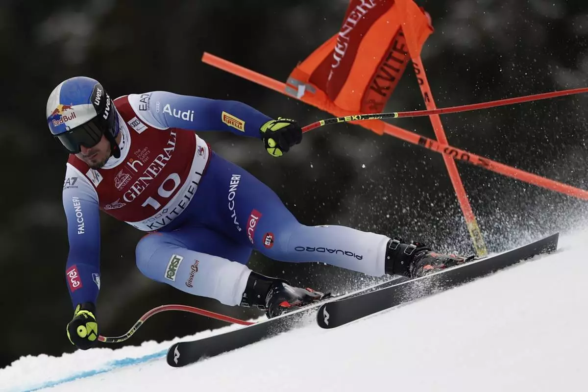 Italy's Dominik Paris speeds down the course during an alpine ski, men's World Cup super G race, in Kvitfjell, Norway, Sunday, March 9, 2025. (AP Photo/Gabriele Facciotti)