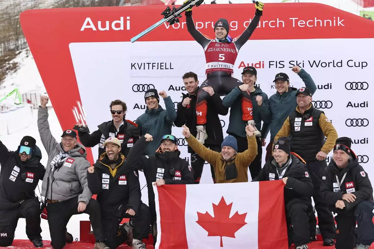 Second placed Canada's James Crawford, celebrates with the team after an alpine ski, men's World Cup downhill, in Kvitfjell, Norway, Saturday, March 8, 2025. (AP Photo/Marco Trovati)
