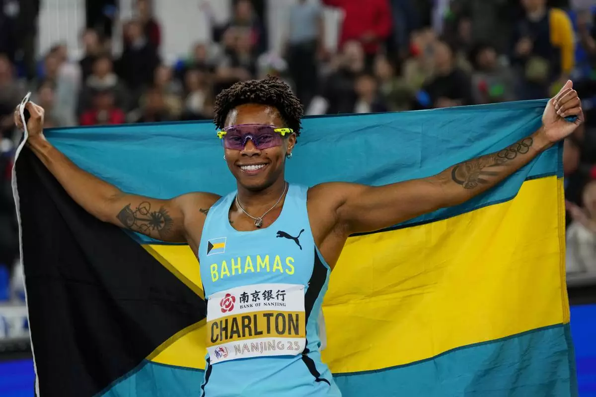 Devine Charlton, of Bahamas, celebrates after winning gold in the women's 60 meter hurdles at the the World Athletics Indoor Championships in Nanjing, China, Sunday, March 23, 2025. (AP Photo/Dar Yasin)