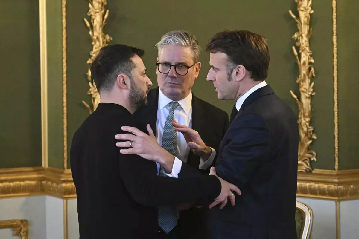 Britain's Prime Minister Keir Starmer, center, Ukraine's President Volodymyr Zelenskyy, left, and France's President Emmanuel Macron meet during the European leaders' summit to discuss Ukraine, hosted by Britain's Prime Minister Keir Starmer, at Lancaster House, London, Sunday March 2, 2025. (Justin Tallis/Pool via AP)