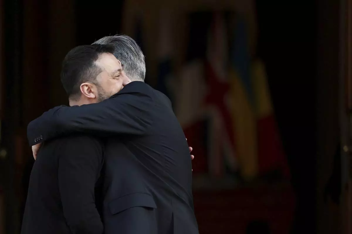 Britain's Prime Minister Keir Starmer, right, welcomes Ukrainian President Volodymyr Zelenskyy to the European leaders' summit to discuss Ukraine, at Lancaster House, London, Sunday March 2, 2025. (Toby Melville/Pool via AP)