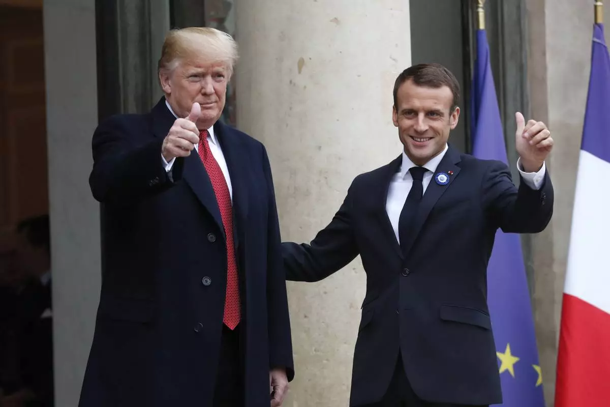 FILE - French President Emmanuel Macron, right, and U.S President Donald Trump thumb up at the Elysee Palace in Paris, Saturday, Nov.10, 2018. (AP Photo/Thibault Camus, File)