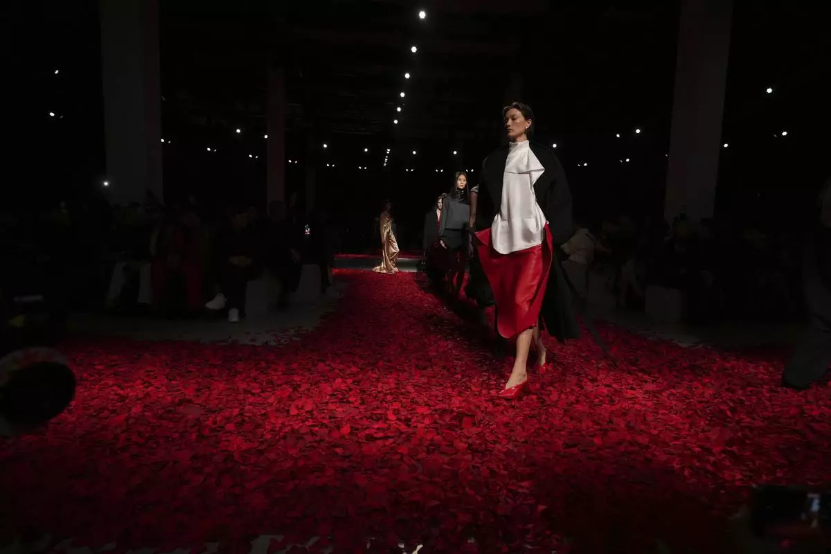 Models wear creations as part of the Ferragamo's Fall/Winter 2025-2026 collection presented in Milan, Italy, Saturday, March 1, 2025. (AP Photo/Antonio Calanni)