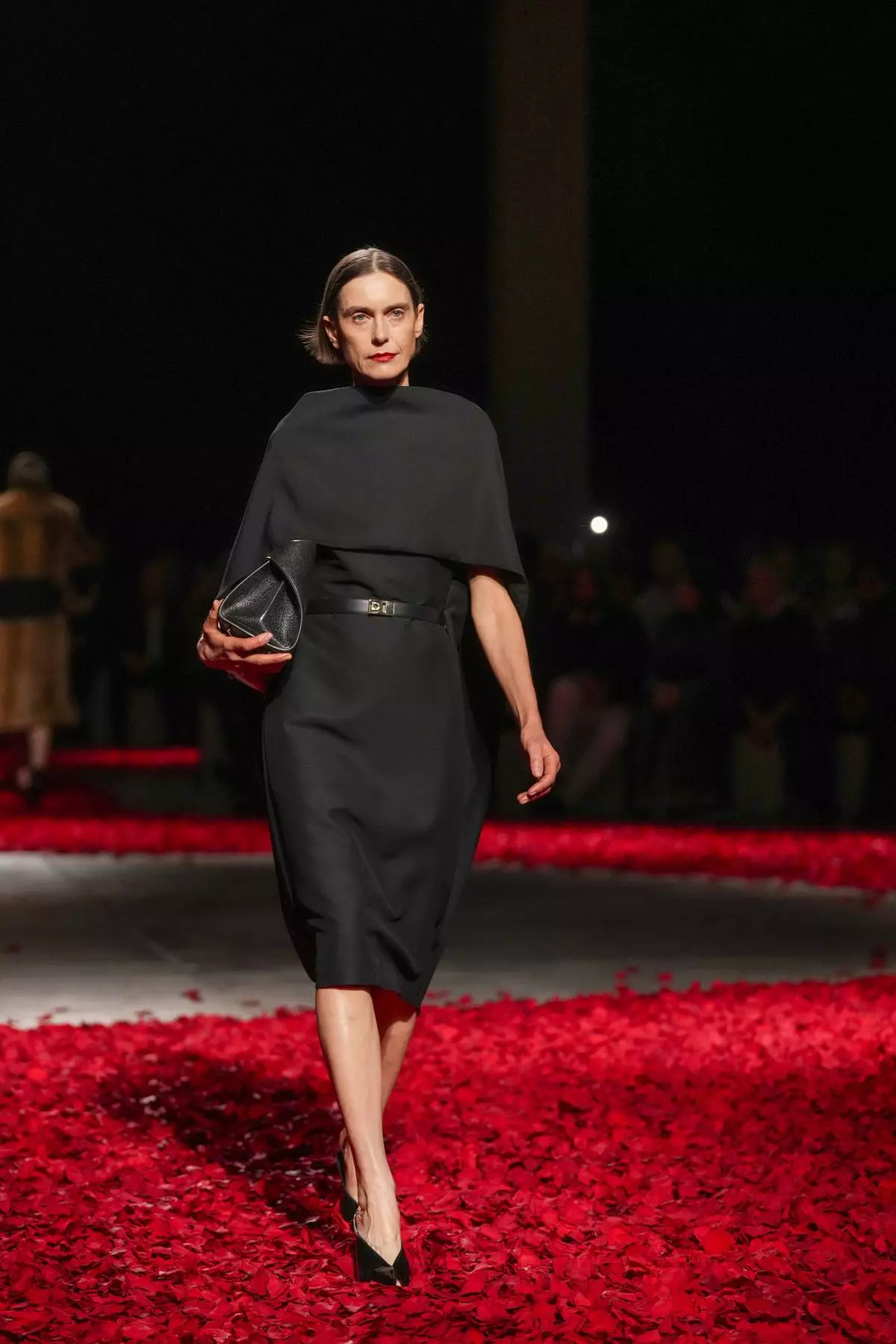 Models wear creations as part of the Ferragamo's Fall/Winter 2025-2026 collection presented in Milan, Italy, Saturday, March 1, 2025. (AP Photo/Antonio Calanni)