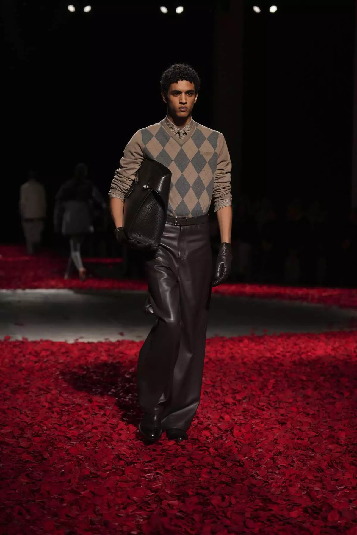 Models wear creations as part of the Ferragamo's Fall/Winter 2025-2026 collection presented in Milan, Italy, Saturday, March 1, 2025. (AP Photo/Antonio Calanni)