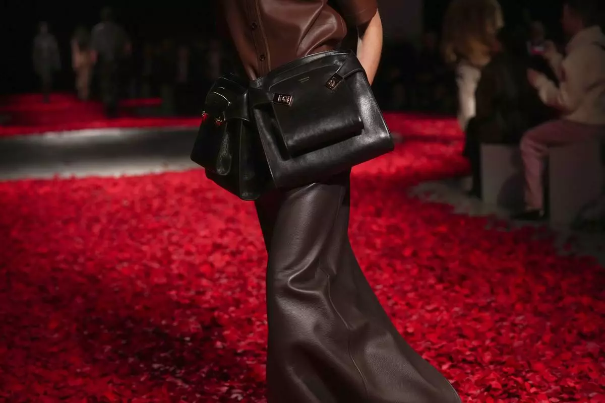 Models wear creations as part of the Ferragamo's Fall/Winter 2025-2026 collection presented in Milan, Italy, Saturday, March 1, 2025. (AP Photo/Antonio Calanni)