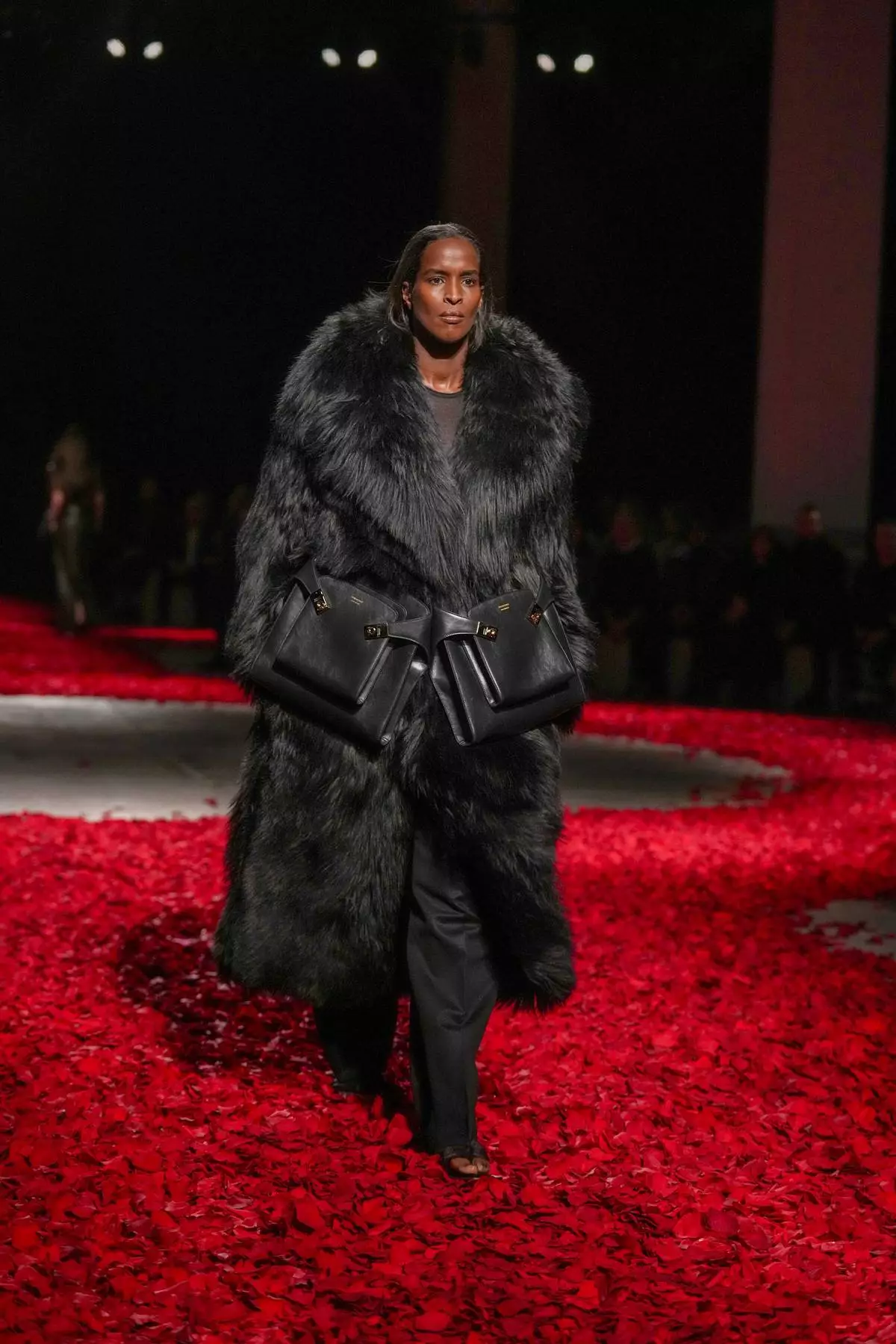 Models wear creations as part of the Ferragamo's Fall/Winter 2025-2026 collection presented in Milan, Italy, Saturday, March 1, 2025. (AP Photo/Antonio Calanni)