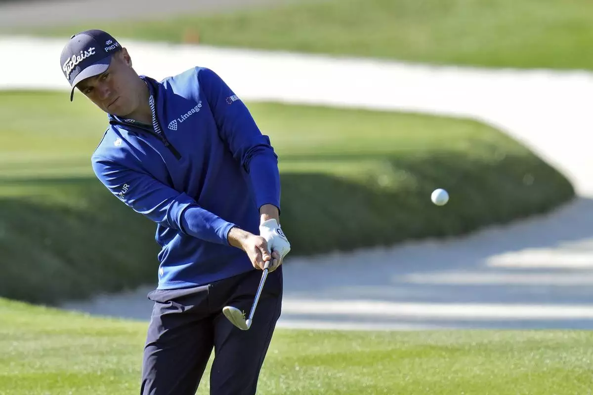 Justin Thomas chips onto the 11th green during a practice round of The Players Championship golf tournament Wednesday, March 12, 2025, in Ponte Vedra Beach, Fla. (AP Photo/Chris O'Meara)