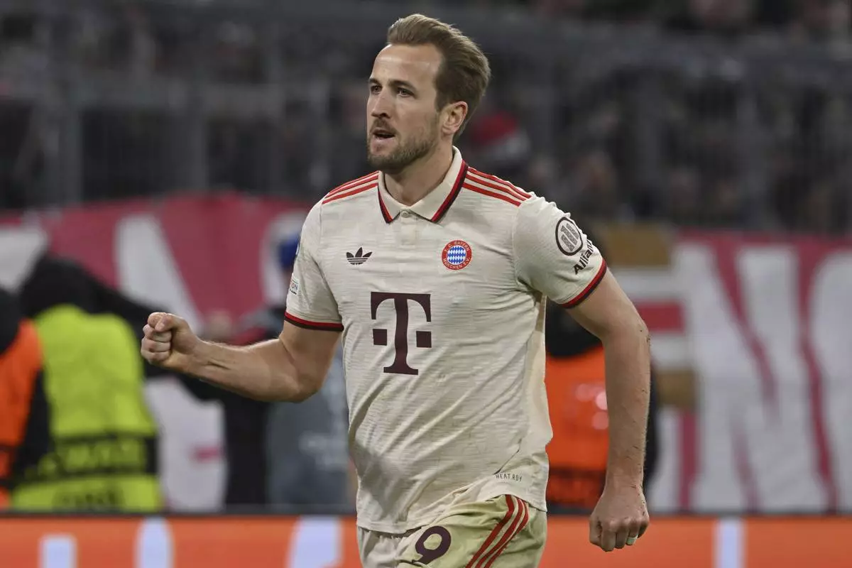 Munich's Harry Kane celebrates after scoring his side's third goal during the Champions League round of 16 first leg soccer match between FC Bayern Munich and Bayer 04 Leverkusen in Munich, Germany, Wednesday, March 5, 2025. (Peter Kneffel/dpa via AP)