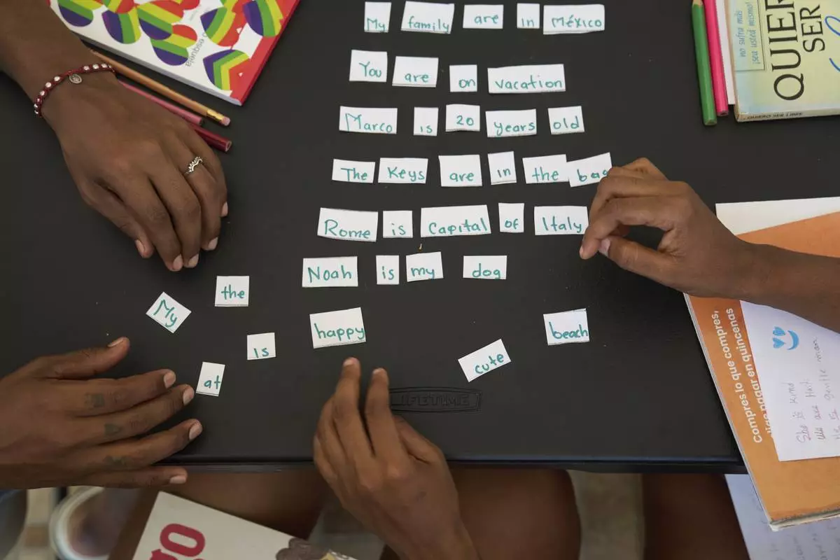 Migrants receive English lessons at Casa Frida, a shelter that supports LGBTQ+ migrants, in Tapachula, Chiapas state, Mexico, Wednesday, March 12, 2025. (AP Photo/Moises Castillo)