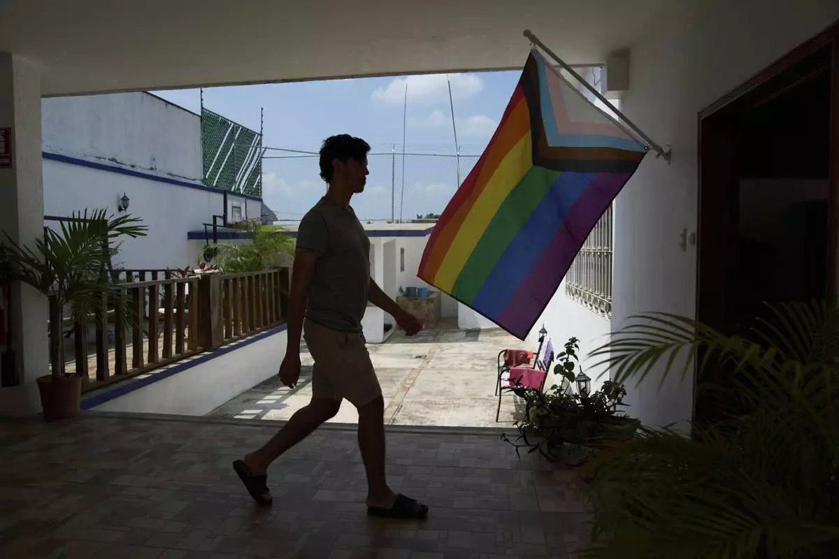 A person walks past a pride flag at Casa Frida, a shelter that supports LGBTQ+ migrants, in Tapachula, Chiapas state, Mexico, Wednesday, March 12, 2025. (AP Photo/Moises Castillo)