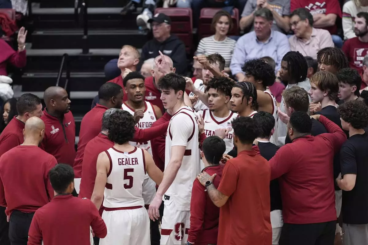 Stanford forward Maxime Raynaud, center, breaks a huddle during a timeout in the second half of an NCAA college basketball game against California, Saturday, Feb. 22, 2025, in Stanford, Calif. (AP Photo/Godofredo A. Vásquez)