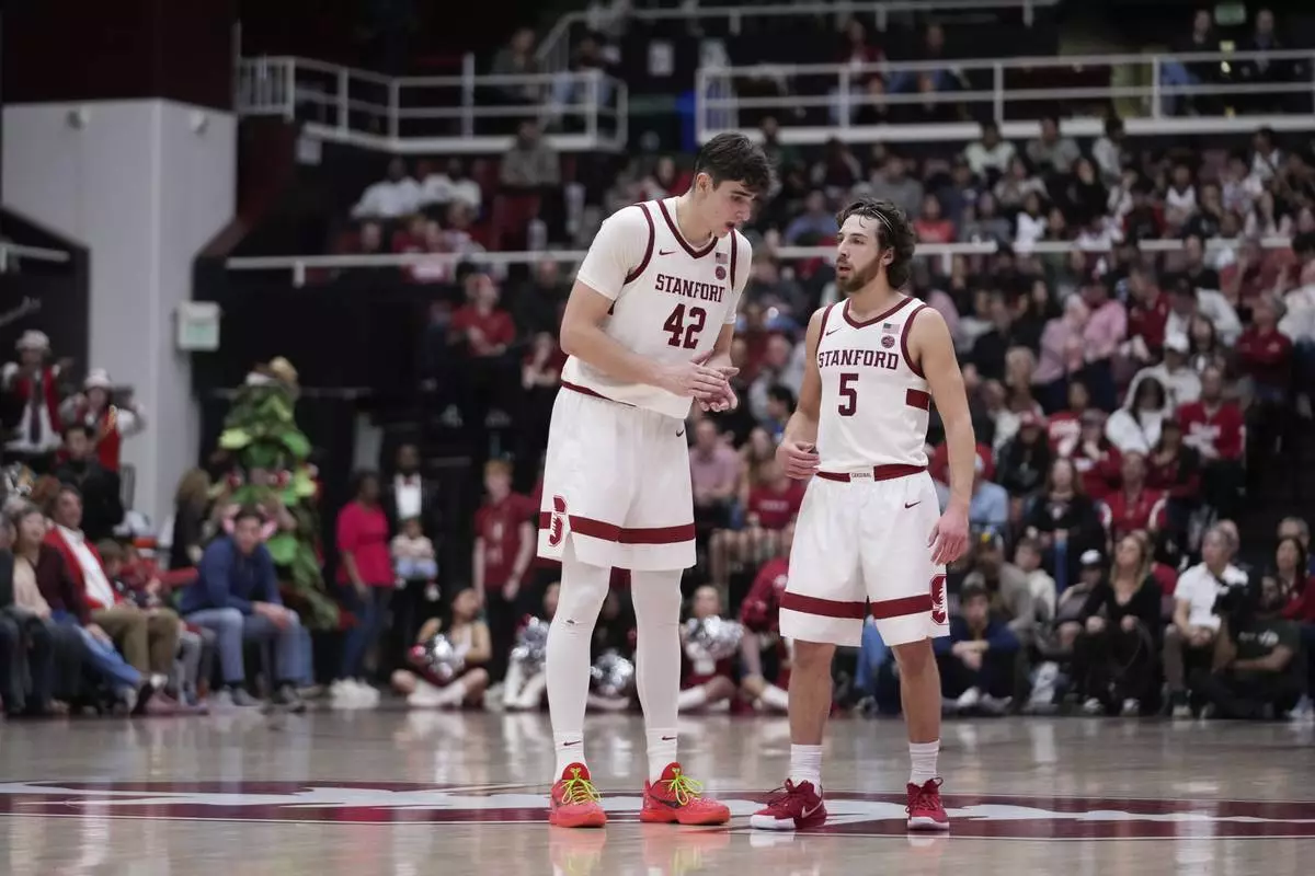 Stanford forward Maxime Raynaud (42) talks with guard Benny Gealer (5) during the second half of an NCAA college basketball game against California, Saturday, Feb. 22, 2025, in Stanford, Calif. (AP Photo/Godofredo A. Vásquez)