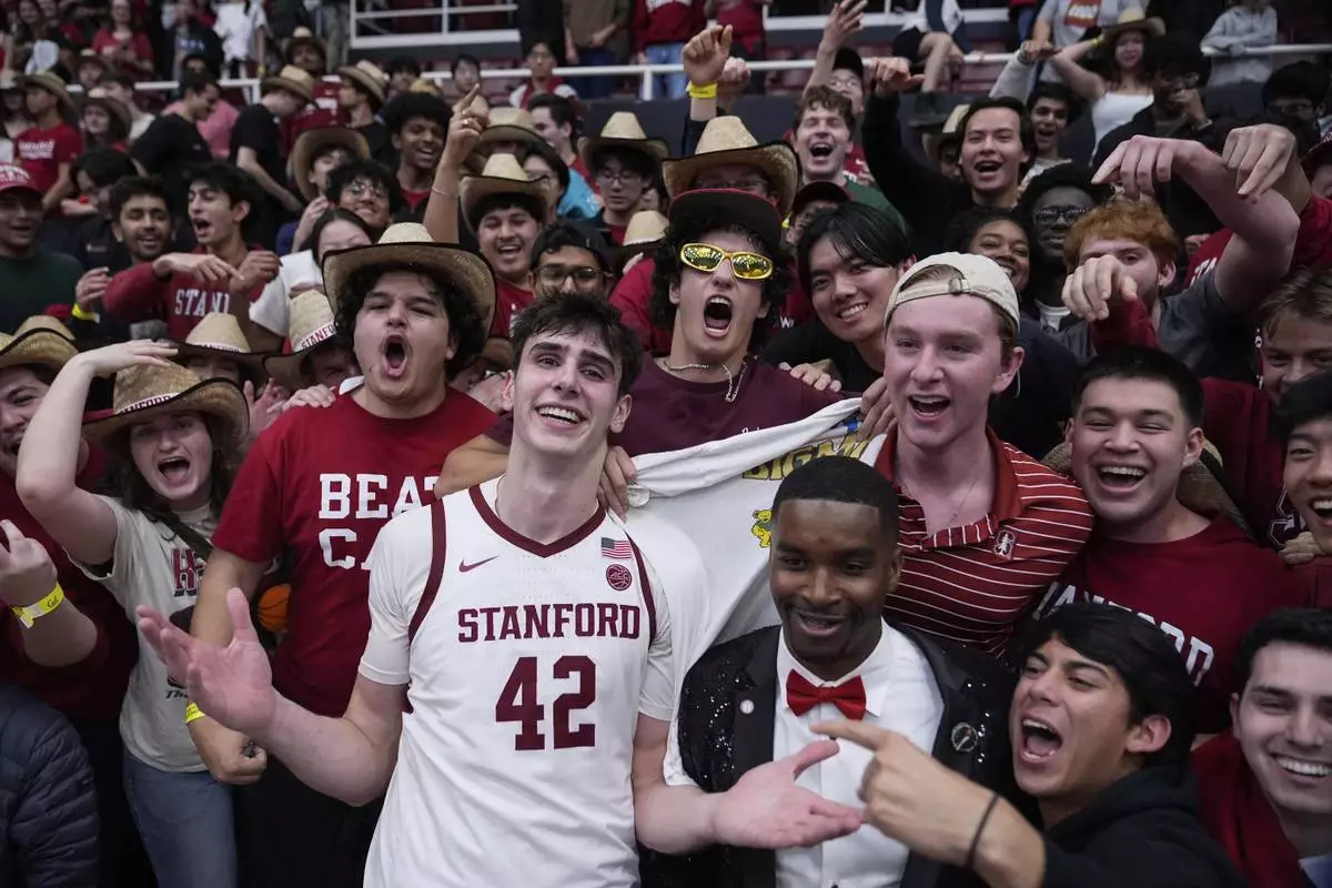 Stanford forward Maxime Raynaud (42) celebrates with fans after the team's victory against California in an NCAA college basketball game Saturday, Feb. 22, 2025, in Stanford, Calif. (AP Photo/Godofredo A. Vásquez)