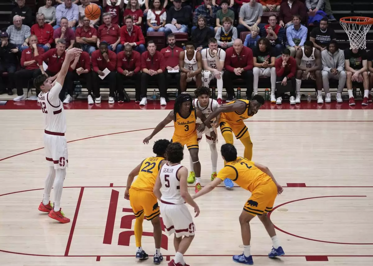 Stanford forward Maxime Raynaud, left, shoots a free throw during the second half of an NCAA college basketball game against California, Saturday, Feb. 22, 2025, in Stanford, Calif. (AP Photo/Godofredo A. Vásquez)