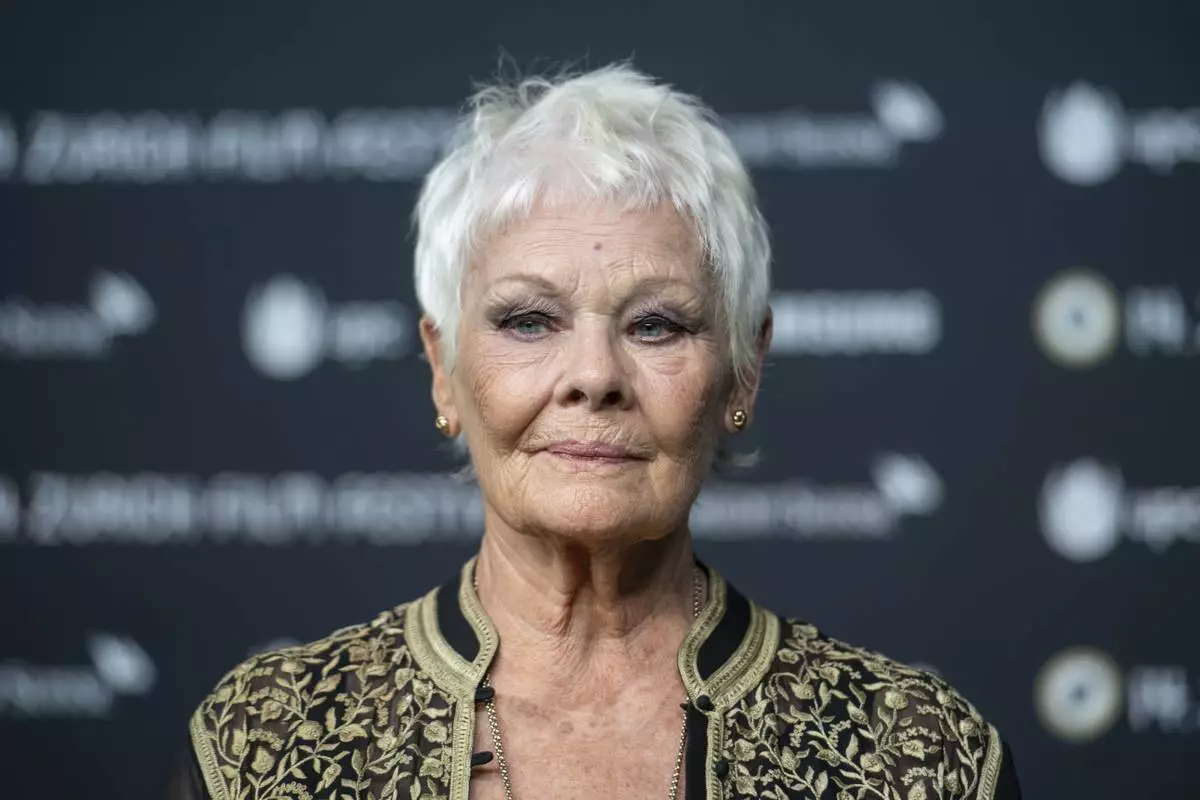 FILE - British actress Judi Dench poses on the Green Carpet before the screening of the movie "Red Joan" at the 14th Zurich Film Festival (ZFF) in Zurich, Switzerland, Wednesday, Oct. 3, 2018. (Patrick Huerlimann/Keystone via AP, File)
