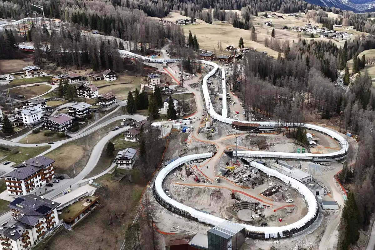Construction work takes place at the Cortina Sliding Center, venue for the bob, luge and skeleton disciplines at the Milan Cortina 2026 Winter Olympics, in Cortina D'Ampezzo, Italy, Tuesday, March 25, 2025. (AP Photo/Luca Bruno)