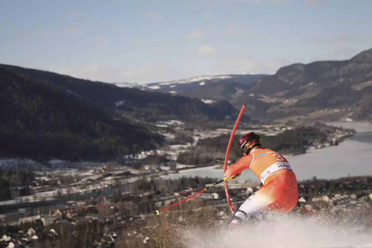 Switzerland's Loic Meillard competes on his way to win an alpine ski, men's World Cup slalom, in Hafjell, Norway, Sunday, March 16, 2025. (AP Photo/Giovanni Zenoni)