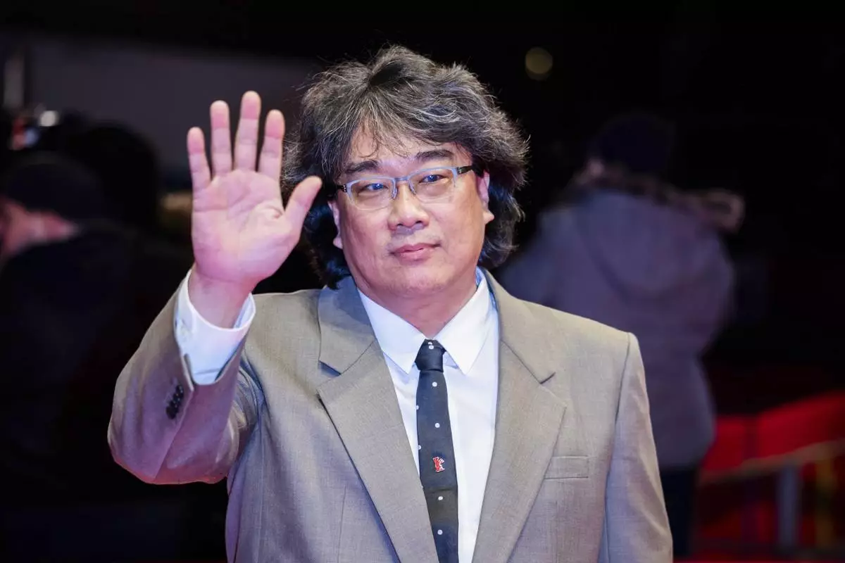 Director Bong Joon Ho poses for the photographers as he arrives for the screening of the film 'Mickey 17' at the International Film Festival, Berlinale, in Berlin, Saturday, Feb. 15, 2025. (Christoph Soeder/dpa via AP)