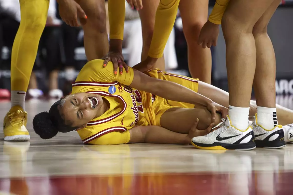 Southern California guard JuJu Watkins (12) reacts on the floor after an injury during the first half against Mississippi State in the second round of the NCAA college basketball tournament Monday, March 24, 2025, in Los Angeles. (AP Photo/Jessie Alcheh)