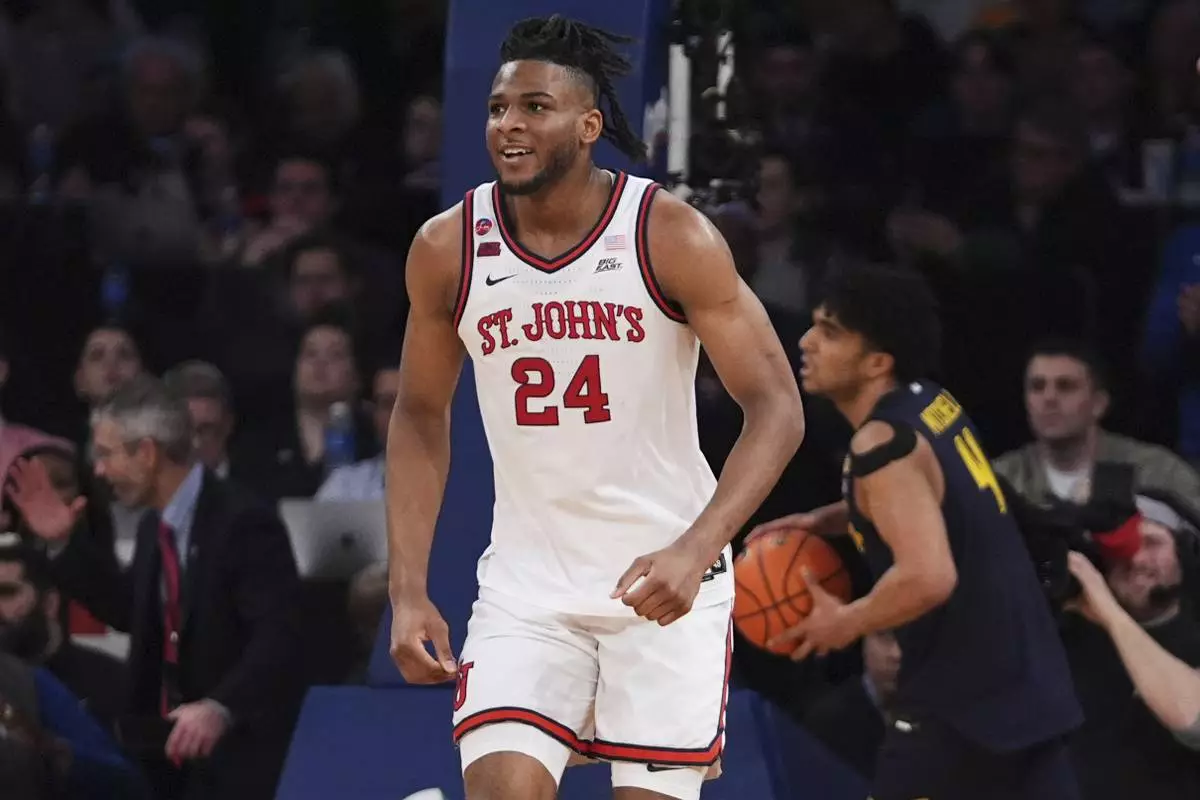 St. John's's Zuby Ejiofor (24) smiles after scoring during the second half of an NCAA college basketball game against the Marquette in the semifinals of the Big East tournament Friday, March 14, 2025, in New York. (AP Photo/Frank Franklin II)