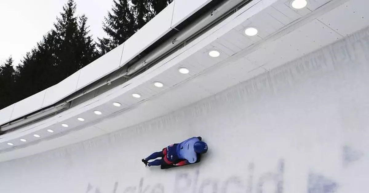 Britain's Matt Weston finishes a dominant run to the men's skeleton world title in Lake Placid