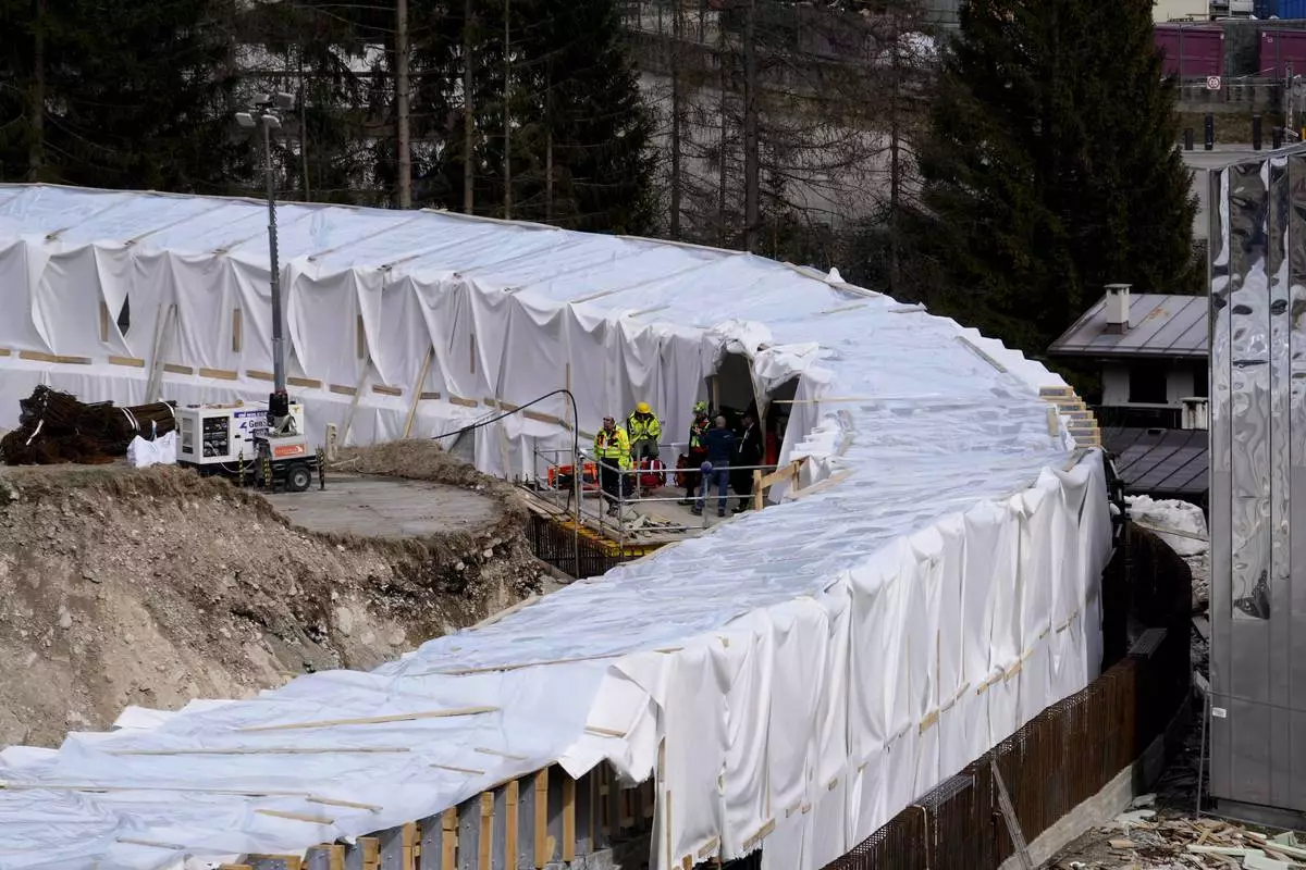 Construction work takes place at the Cortina Sliding Center, venue for the bob, luge and skeleton disciplines at the Milan Cortina 2026 Winter Olympics, in Cortina D'Ampezzo, Italy, Tuesday, March 25, 2025. (AP Photo/Luca Bruno)