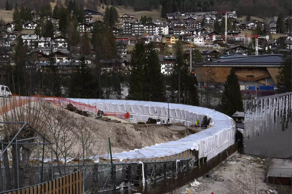 Construction work takes place at the Cortina Sliding Center, venue for the bob, luge and skeleton disciplines at the Milan Cortina 2026 Winter Olympics, in Cortina D'Ampezzo, Italy, Tuesday, March 25, 2025. (AP Photo/Luca Bruno)