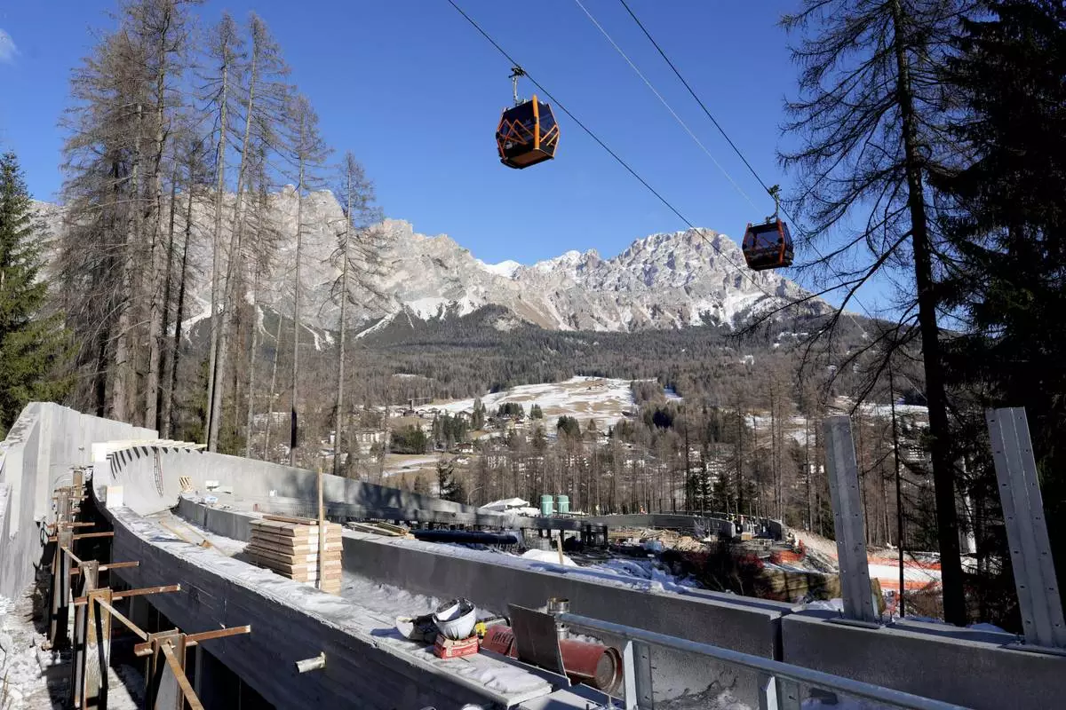 FILE - Construction work takes place at the Cortina Sliding Center, venue for the bob, luge and skeleton disciplines at the Milan Cortina 2026 Winter Olympics, in Cortina d'Ampezzo, Italy, Thursday, Jan. 16, 2025. (AP Photo/Giovanni Auletta, file)