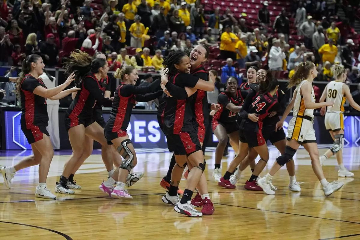 San Diego State players celebrate after defeating Wyoming in an NCAA college basketball championship game at the Mountain West Conference tournament Wednesday, March 12, 2025, in Las Vegas. (AP Photo/John Locher)