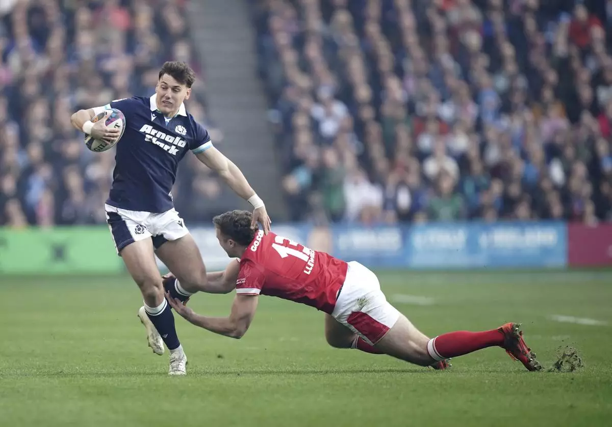 Scotland's Tom Jordan, left, tackled by Wales's Max Llewellyn during the Men's Six Nations rugby union match between Scotland and Wales the Murrayfield Stadium, Edinburgh, Saturday, March 8, 2025. (Jane Barlow/PA via AP)