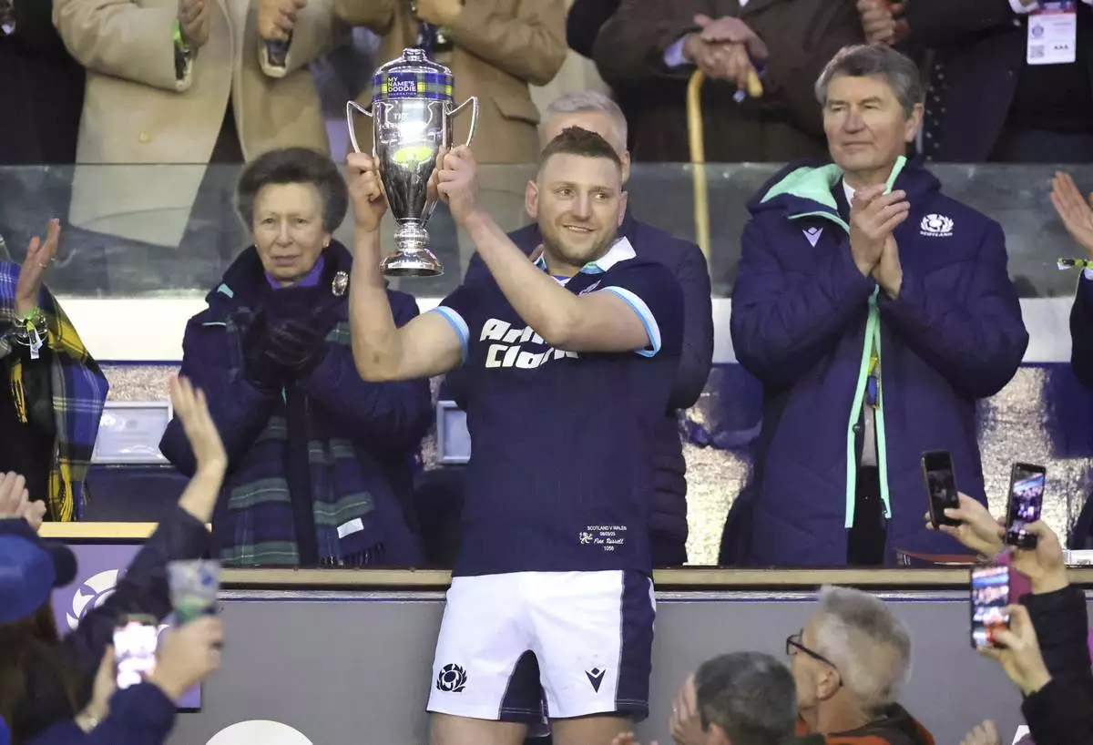 Scotland's Finn Russell lifts the The Doddie Weir Cup following the Men's Six Nations rugby union match the Murrayfield Stadium, Edinburgh, Saturday, March 8, 2025. (Steve Welsh/PA via AP)