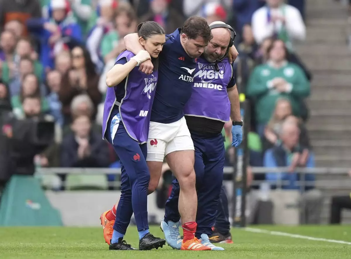 France's Antoine Dupont leaves the pitch after picking up an injury during the Six Nations rugby union match between Ireland and France, at Aviva Stadium, Dublin, Ireland, Saturday, March 8, 2025. (Niall Carson/PA via AP)
