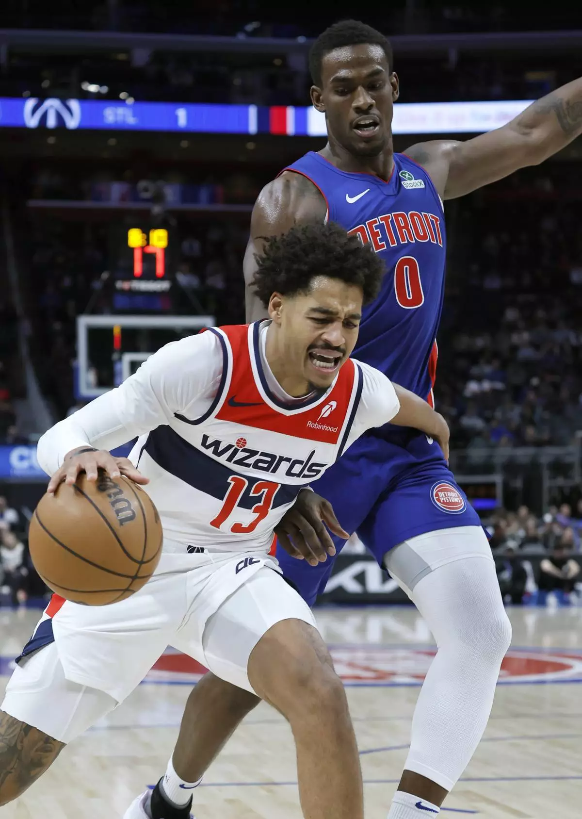 Washington Wizards guard Jordan Poole (13) tries to work around Detroit Pistons center Jalen Duren (0) while going to the basket during the first half of an NBA basketball game Tuesday, March 11, 2025, in Detroit. (AP Photo/Duane Burleson)